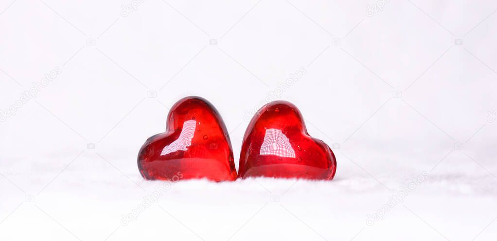 Two red hearts on a white background . Postcard for Valentine's Day.Happy Valentine's Day.Copy space