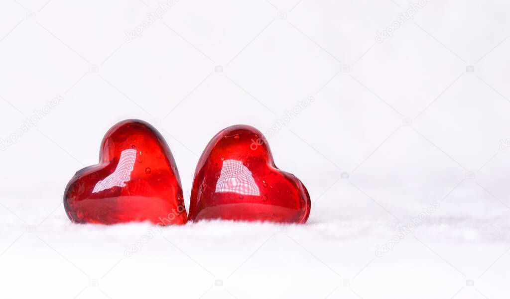 Two red hearts on a white background . Postcard for Valentine's Day.Happy Valentine's Day.Copy space