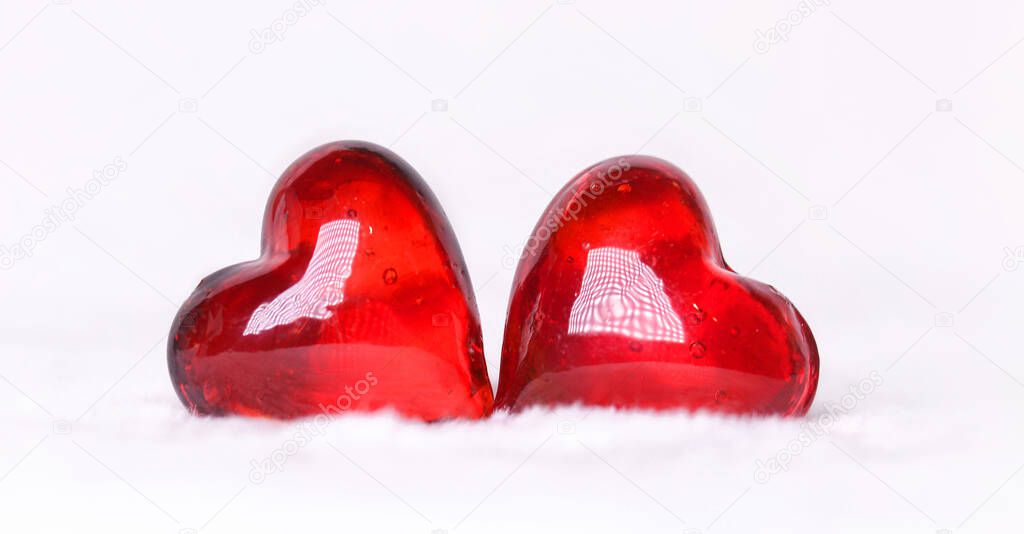 Two red hearts on a white background . Postcard for Valentine's Day.Happy Valentine's Day.Copy space