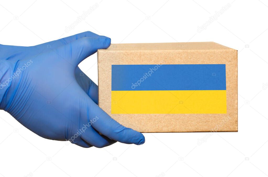 Hand in blue medical glove gives cardboard box.?oncept of safety mail goods courier delivery in virus or coronavirus quarantine. ?opy space on white background