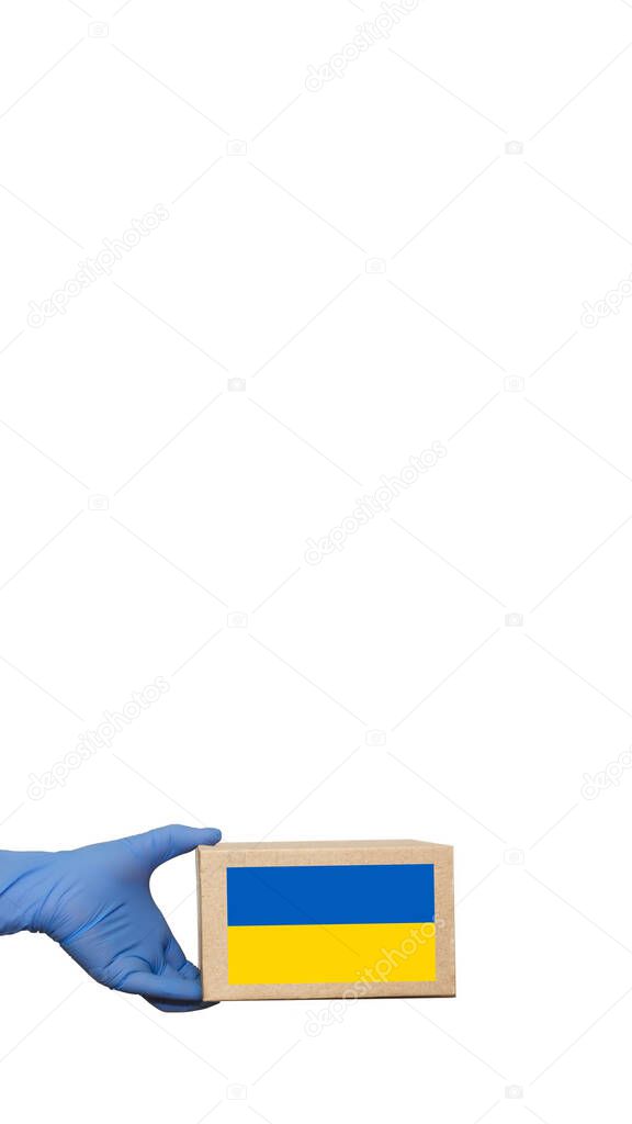 A volunteer holds a box of aid for Ukrainian refugees and poor citizens who find themselves in a war between Ukraine and Russia.Humanitarian aid concept.Donate for refugees.Copy space. Banner