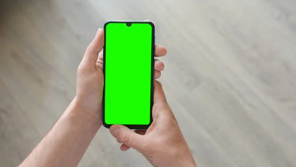 Man Holds Smartphone Green Screen Mockup Copy Space Text — Stockfoto