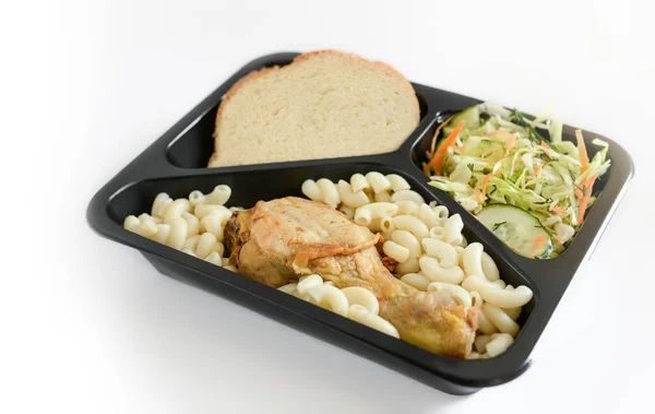 Box with lunch (salad, chicken leg, pasta,bread) on a white background. Free lunches for the needy and IDPs. Lunch delivery concept. Online orders