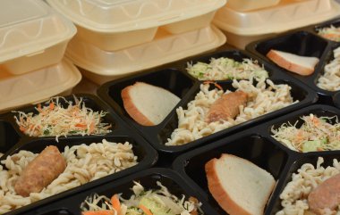 Beslenme çantaları (salata, tavuk budu, makarna). Muhtaç ve içten dışlanmış insanlar için bedava öğle yemekleri. Yemek teslimatı konsepti. Çevrimiçi emirler