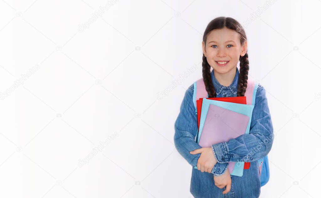 Happy teenage school child hold books white background, knowledge day. Back to school. Copy space