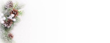 Christmas New Year background with christmas tree, pinecone, berries and snow on a white background. Copy space for your text. Banner. Flat lay.