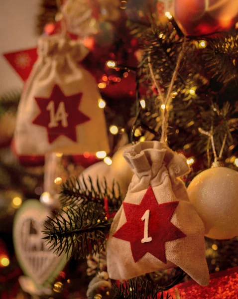 Christmas background. Advent calendar .Advent calendar in the form of an eco bags hangs on the Christmas tree