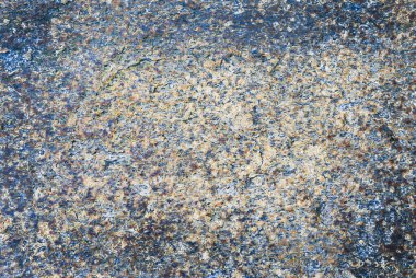 Mavimsi ve sıcak tonlarda granüler taş dokusu. Arkaplan Kavramı.
