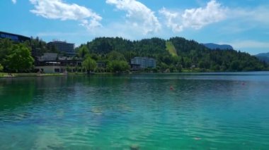 Beautiful idyllic panorama view of Lake Bled with Bled Island, Church of the Mother of God, Bled Castle and Slovenian Julian Alps on sunny summer day with blue sky cloud, Bled, Slovenia.
