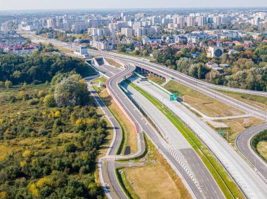 Otoyol ya da çevre yolu. Pek çok şeridi olan geniş bir yol. Taşımacılık için otoyol. Varşova Polonya yollarında arabalar ve kamyonlar için yol. Panorama manzarası. Hava görüntüsü. S2 Wilanow Tüneli
