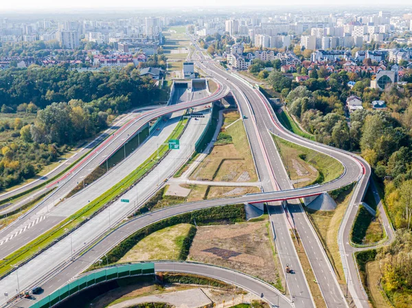 Highway or Freeway road. Wide road with many lanes. Highway for any transportation. Road for cars and trucks Warsaw Poland roads. Panorama landscape. Aerial view.  S2 Wilanow tunnel