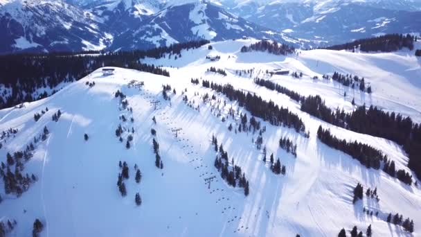 Panoramic top view from drone on cable way in ski resort. Ski lift elevator transporting skiers and snowboarders on snowy winter slope at mountain resort, many people. UHD 4k video — Stock Video