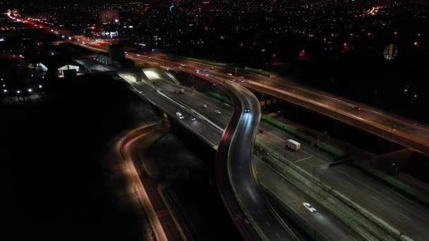 Drone disparo de tráfico nocturno en una autopista que muestra coches y carriles de luz con túnel y viaductos fuera de la ciudad de Varsovia, Polonia. Mover la cámara hacia adelante. — Vídeos de Stock