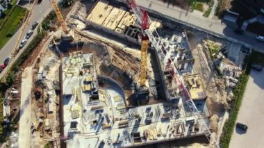 Yüksek inşaat alanı. Arka planda mavi gökyüzü ve şehir manzaralı büyük endüstriyel bir vinç. Beton levhalar ağırlık dengesi. Karşı ağırlık. Hava aracı görüntüsü. Metropolis Şehir Geliştirme