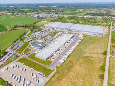 Aerial Shot of Industrial Loading Area where Many Trucks Are Unloading Merchandis