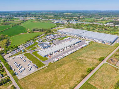Aerial Shot of Industrial Loading Area where Many Trucks Are Unloading Merchandis
