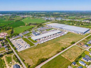 Aerial Shot of Industrial Loading Area where Many Trucks Are Unloading Merchandis