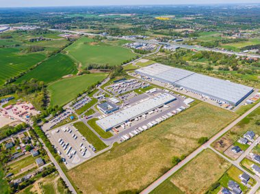 Aerial Shot of Industrial Loading Area where Many Trucks Are Unloading Merchandis