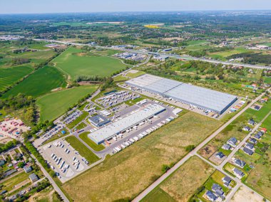 Aerial Shot of Industrial Loading Area where Many Trucks Are Unloading Merchandis