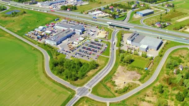 Aerial view of goods warehouse. Logistics center in industrial city zone from above. Aerial view of trucks loading at logistic center — Stock Video