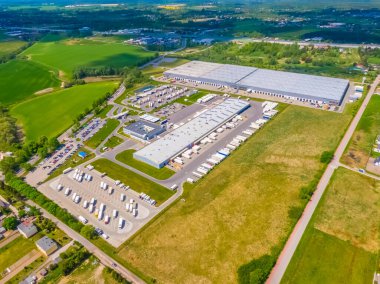 Malzeme deposunun havadan görüntüsü. Sanayi bölgesindeki lojistik merkezi yukarıdan. Lojistik merkezde yüklenen kamyonların hava görüntüsü