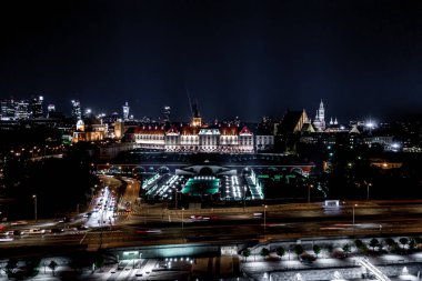 Aerial view of old buildings, castles and a church in the old city of Warsaw. Cityscape of old buildings and architecture in the old town in Warsaw. Night time