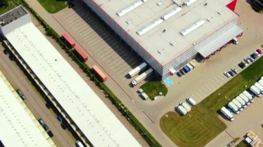 Aerial footage of a large shopping centre and car parks located in the city