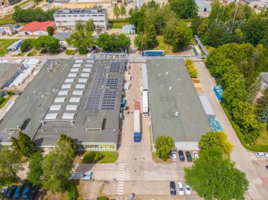 Malzeme deposunun havadan görüntüsü. Sanayi bölgesine yukarıdan lojistik merkezi teslimatı. Lojistik merkezde yüklenen kamyonların hava görüntüsü