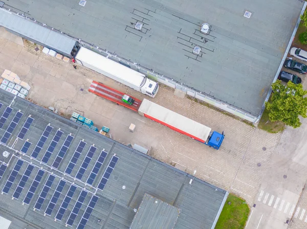 Aerial Shot of Industrial Warehouse/ Storage Building/ Loading. logistics center from above. Aerial view of industrial buildings and equipment machines