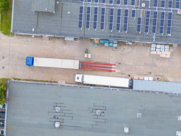 Aerial Shot of Industrial Warehouse/ Storage Building/ Loading. logistics center from above. Aerial view of industrial buildings and equipment machines