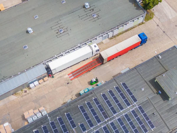 Aerial Shot of Industrial Warehouse/ Storage Building/ Loading. logistics center from above. Aerial view of industrial buildings and equipment machines