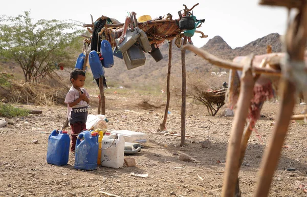 Taiz Yemen - 18 Şubat 2022: Taiz, Yemen 'deki savaştan sürülenler için kamplarda su arayan üzgün bir çocuk görülüyor 