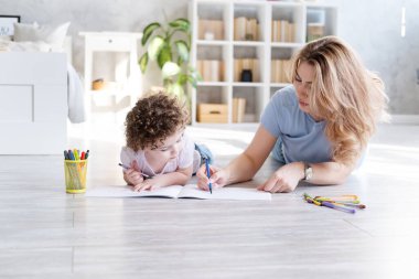 # Genç anne ve kıvırcık kız çiziyor # # Renkli kalemlerle çiziyor #