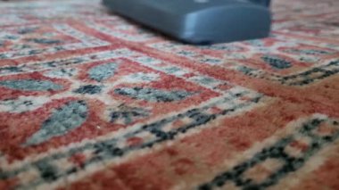 Elektrikli süpürgenin yakın çekimi. Halıyı süpüren biri..