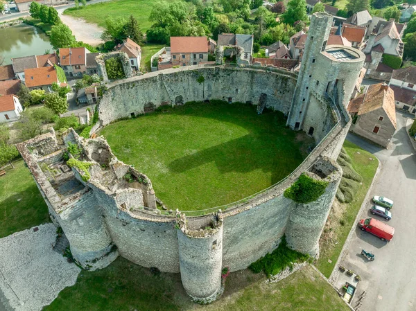 Aerial ground plan top down view of Billy castle in Central France with donjon, four semi circle towers and fortified gate house on a hilltop