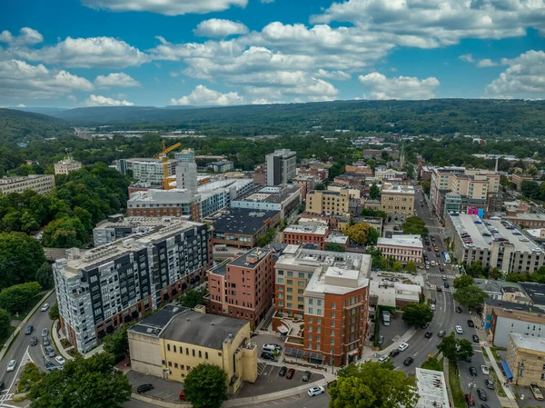 Aerial view of downtown Ithaca New York with modern apartment buildings, Ivy League school Cornell University and cloudy sky near the Finger Lakes (Cayuga)