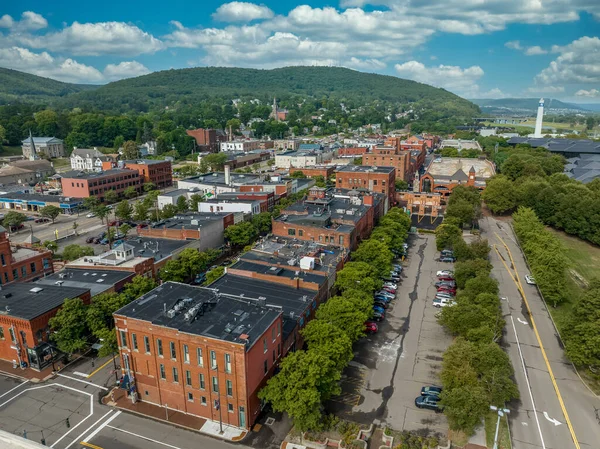 Aerial view of Corning Market Street downtown area with brick facade buildings next to the Glass factory
