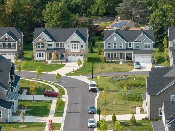 Aerial view of new modern neighborhood street with luxury single family homes , drive ways in Maryland USA