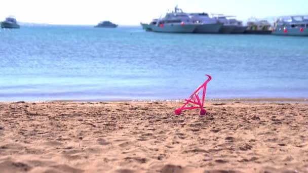Toy pram on the beach — Stock Video