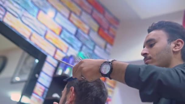 Fryzjer strzyże męskie włosy nożyczkami u fryzjera — Wideo stockowe