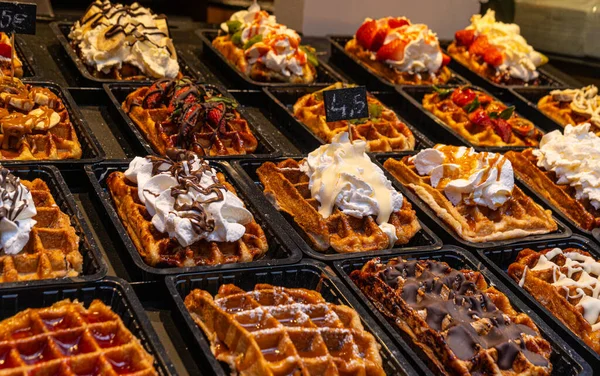 Belgian waffles with colorful toppings on showcase. Brussels — Stock Photo, Image
