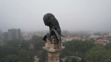 Cinematic Circle drone view of monument at Rotunda da Boavista a foggy day. Porto, Portugal. 