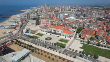 Aerial circle drone view of City of Povoa de Varzim on a bright sunny summer day, Porto region, Portugal. 