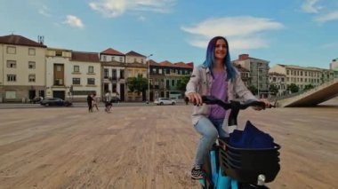 Woman Riding On Rent electric bicycle. Urban Style Green Energy City Transport. Ecological Transportation Mobility In City.