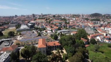 Aerial drone view of Porto city, typical tile red roofs, houses, and solar-powered battery system at sunny day, Portugal