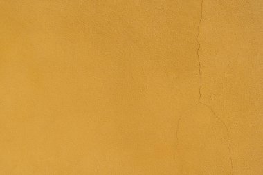 Old yelloew wall with fissure texture abstract background