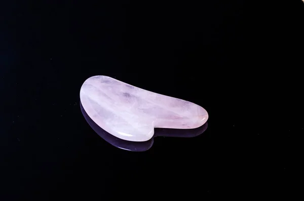 rose quartz facial roller and massage stone gua sha isolated on white background, flat la