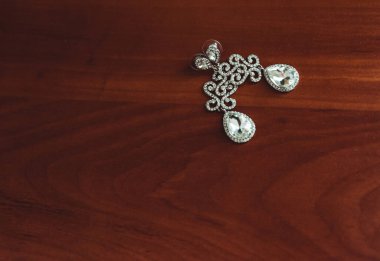 Kare elmas mücevherler, beyaz elbiseli kadın ellerinde.