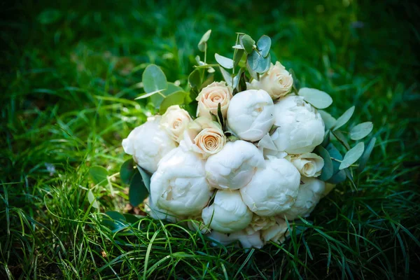 Wedding bouquet made of white roses wedding bouquet of the bride on the lawn or table