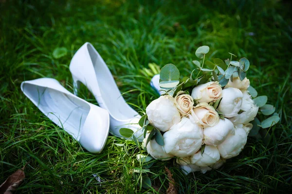 Wedding bouquet made of white roses wedding bouquet of the bride on the lawn or table
